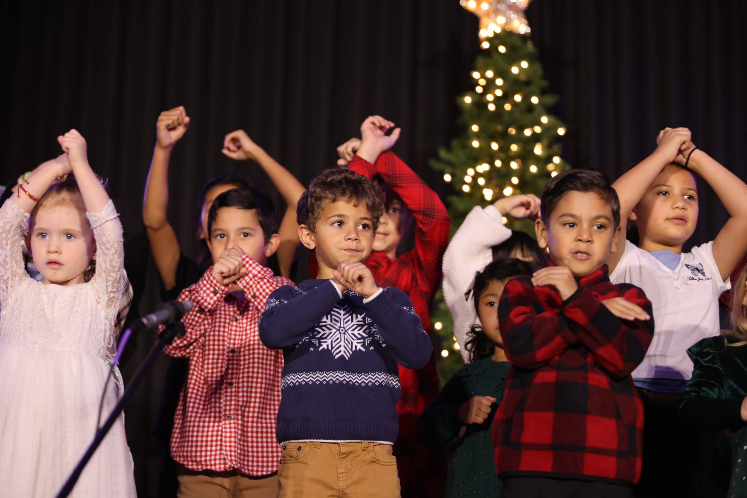 Kids performing with hand motions at Tekoa Church's Christmas program